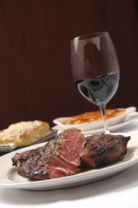 A 16-ounce rib-eye steak, served with baked creamed spinach and scalloped potatoes with truffle cream and Gruyere cheese, at 801 Chophouse.