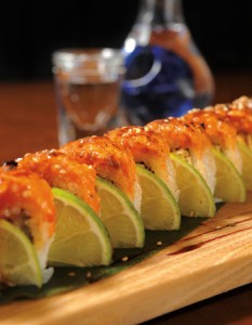 Wasabi Chi - The Des Moines Monster Roll consists of spicy smoked crab, mango, cucumber and salmon, topped with honey miso sauce and Japanese spices.