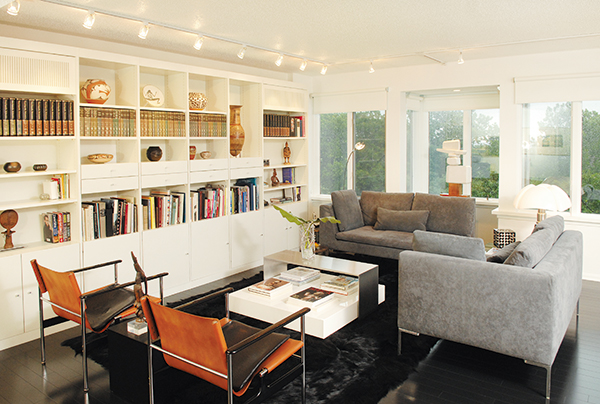 In the living room, two Charles Pollock chairs complement the sleek sofa and the coffee table, both from Projects Contemporary Furniture.