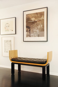 A lithograph by renowned artist Jasper Johns hangs over a 1929 bench by  Eliel Saarinen. On the wall to the left is a woodcut by Italian artist Francesco Clemente (top) and a lithograph by American artist Richard Diebenkorn.