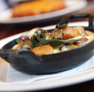 Touches of fried sage and nutmeg finish the tender sweet potato gnocchi. The hash browns with aged cheddar (background) is another winning side dish.