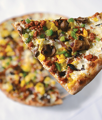 Scrambled eggs and Graziano Bros. sausage with a layer of fresh mozzarella cheese make the thin and chewy breakfast pizza at Centro a favorite.