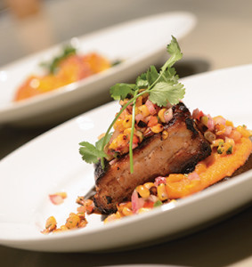 Roasted corn salsa atop pork belly with mole negro sauce.