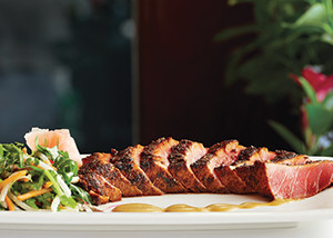 Seared ahi tuna, served with a fresh vegetable salad and spicy mustard sauce, is on the menu’s list of small plates.