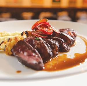 A salad topper adds brightness to the deep flavor of the hanger steak.