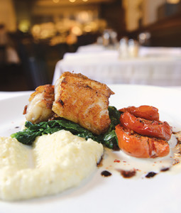 Sauteed escarole and a slow-cooked tomato elevate the rich, pan-seared monkfish. 