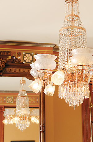 An elaborate chandelier serves as a brilliant centerpiece for this parlor in the 1881 Maish House on Center Street, now the home of Marty Gross. 