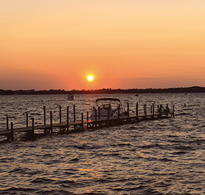 For frequent visitors Kathy McNamara-Pitsor and Deon Pitsor, the beauty of Okoboji is captured in the light of the setting sun.