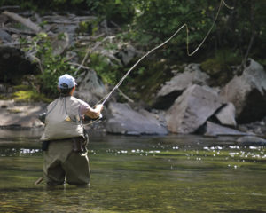 No bobber-and-worm enterprise, fishing in the Tetons involves casting flies to trout in mountain streams.